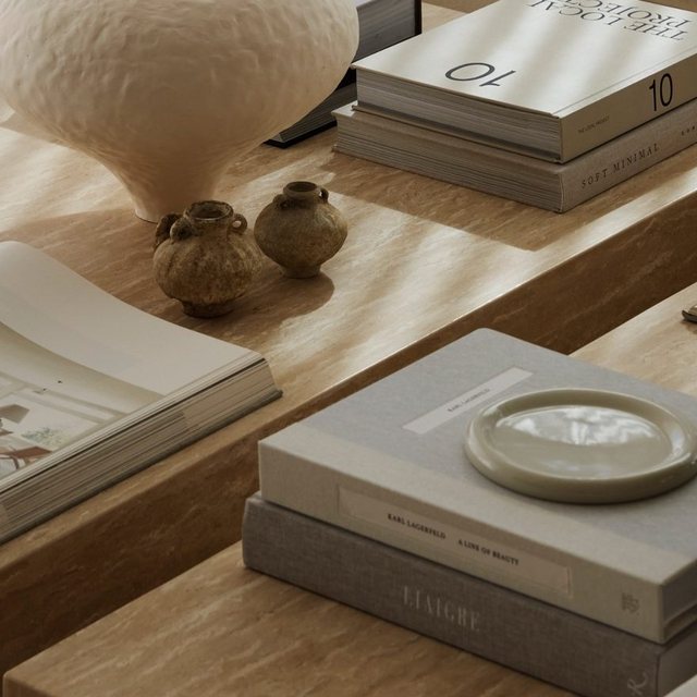Travertine table with books and vessels